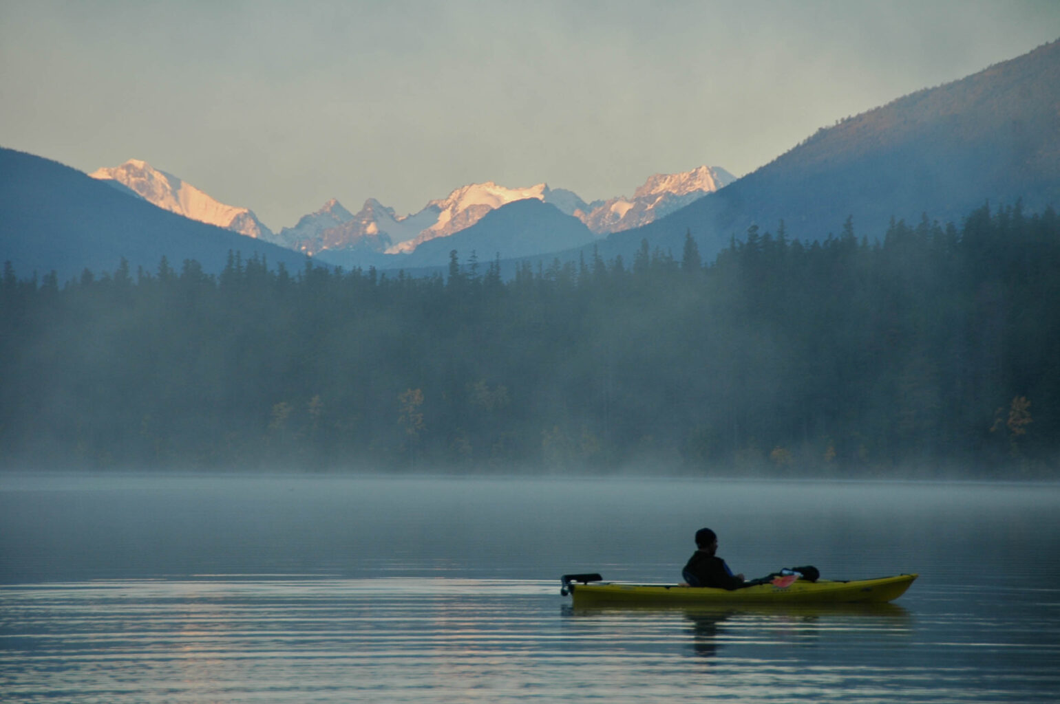 Calm misty morning on a lake in Canada.