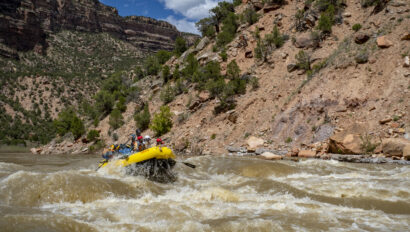 A raft full of people goes through a rapid on the Yampa River in Dinosaur National Monument in Utah