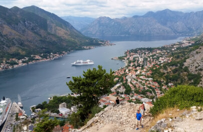 Guests hike high above a town overlooking the water in Croatia.