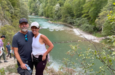 A couple poses high above the river in Croatia.