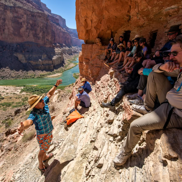 OARS guide provides interpretive talk to guests trying to stay out of the sun at the Nankoweap graneries high above the Colorado River in Grand Canyon