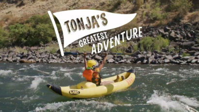Woman inflatably kayaking on a river
