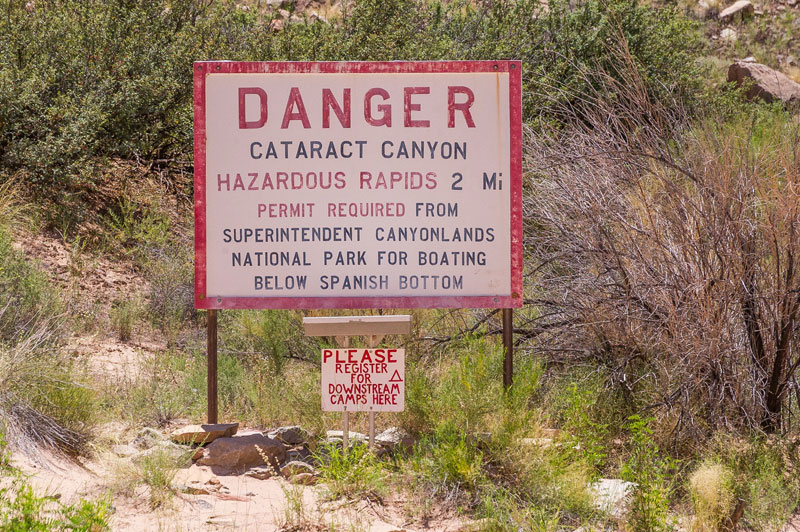 A sign at the beginning of Cataract Canyon that warns boaters of harardous rapids coming in 2 miles.