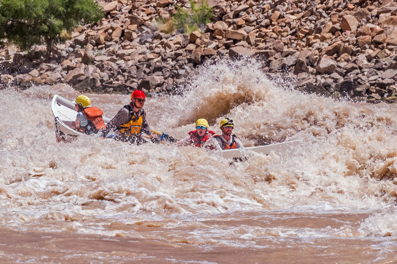 A dory plows through big whitewater on the Colorado River