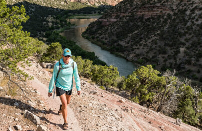 A hiker walks along a trail high above the Green River on a Gates of Lodore trip.