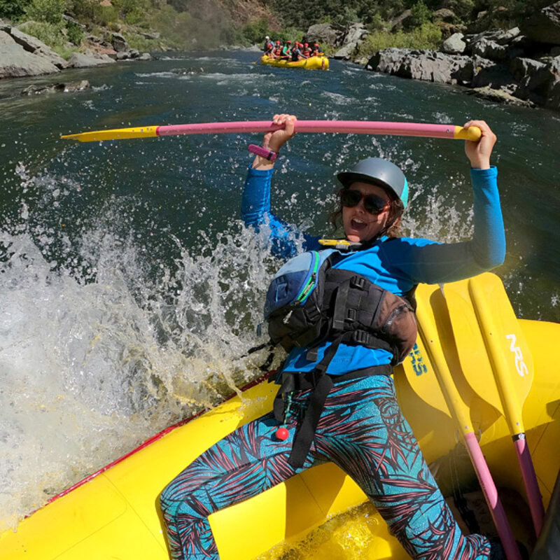 A guide having a blast going through a rapid on the Middle Fork American River.