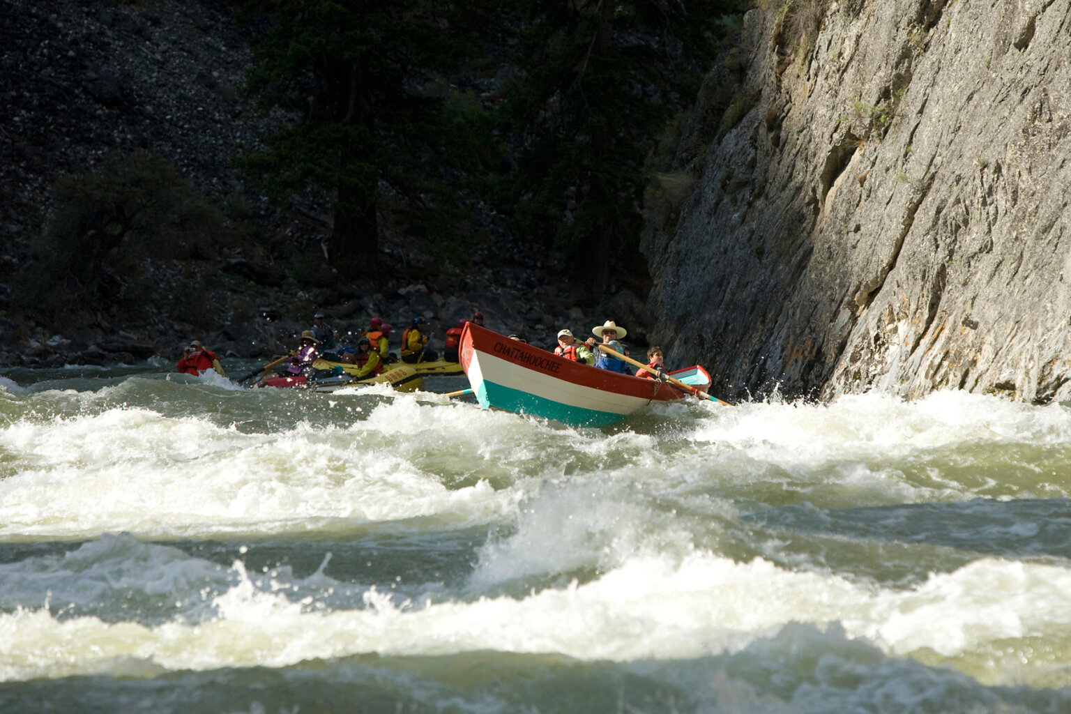 A dory and oar rafts plow through whitewater on the Middle Fork of the Salmon River in Idaho.