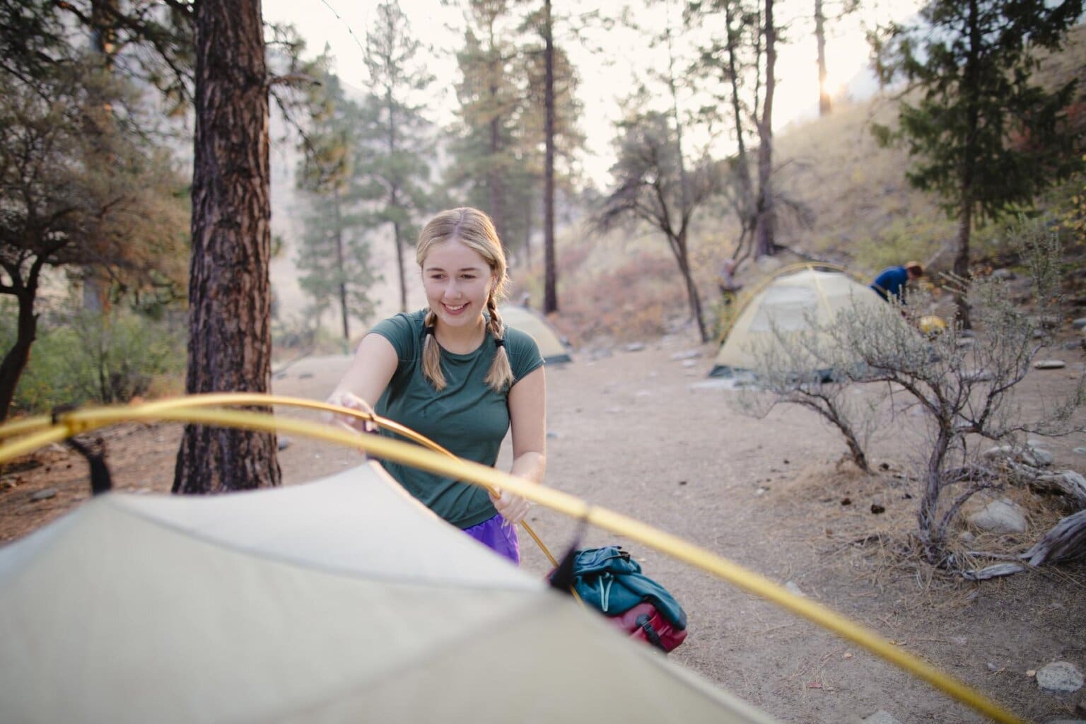 A girl sets up a tent on a rafting trip on the Middle Fork of the Salmon River in Idaho