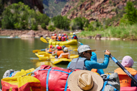 line of rafts in a group trip on a river.