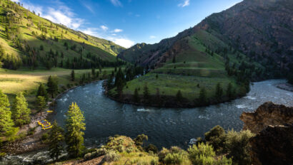 Vibrant green landscape view of camp on an OARS Middle Fork of the Salmon River trip.