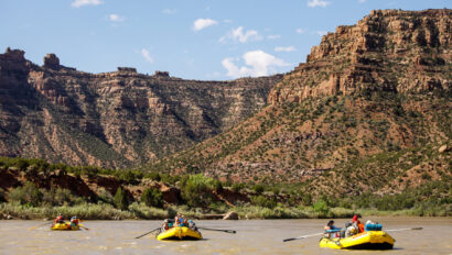 Three yellow rafts float down the Green River in Desolation Canyon, Utah.