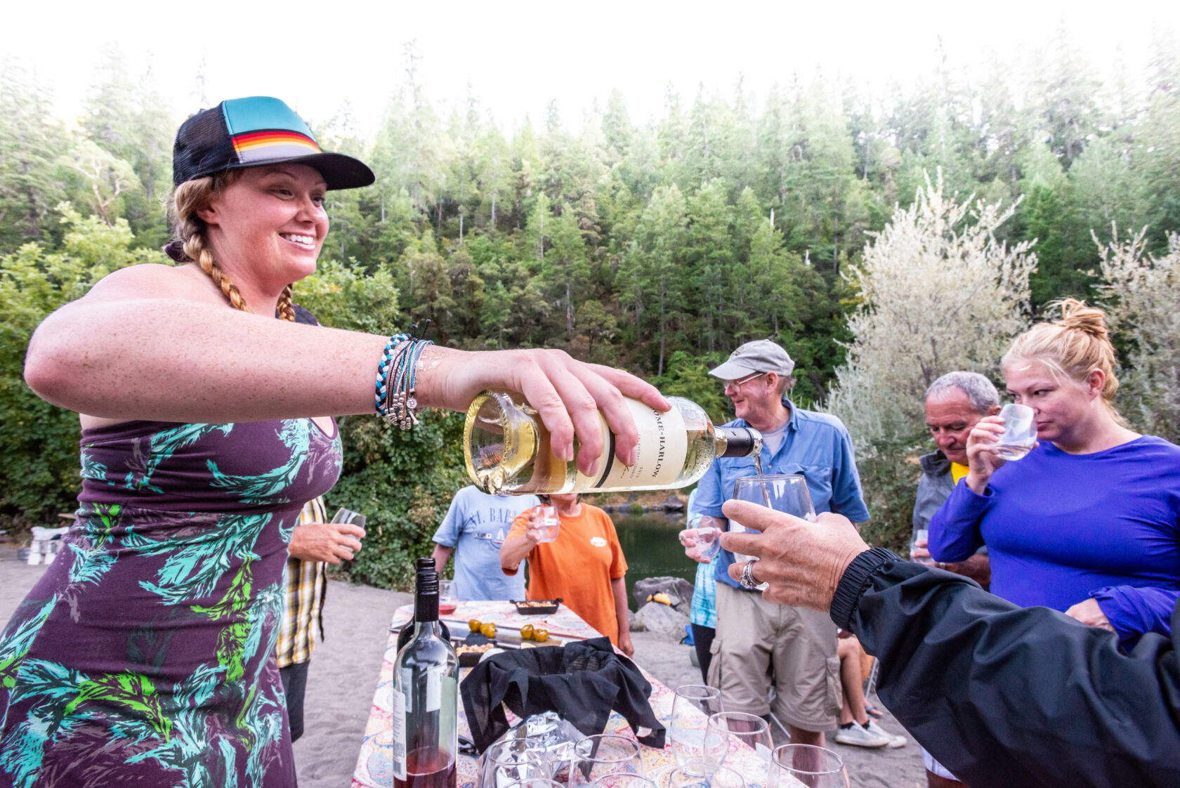 Guide pouring wine for guests.
