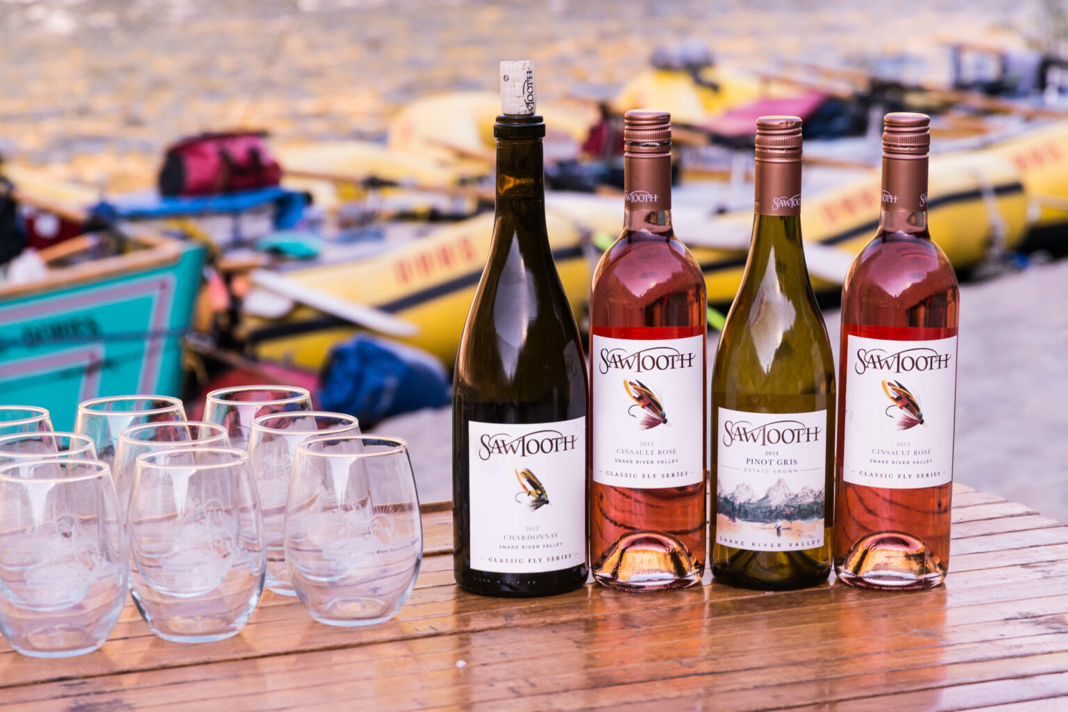 Wine bottles lined up on a table on the Main Salmon River bank.