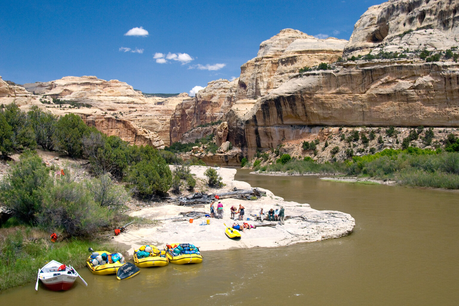 View from above of guides preparing lunch while guests relax on the beach along the Yampa River.