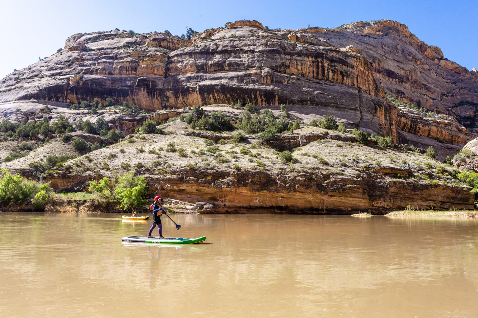 A young guest on a stand up paddle board on the Yampa River.