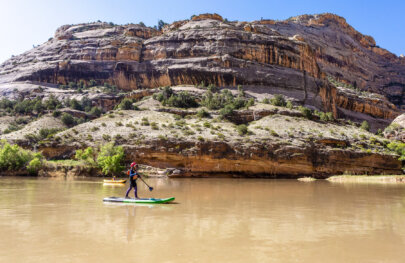 A young guest on a stand up paddle board on the Yampa River.